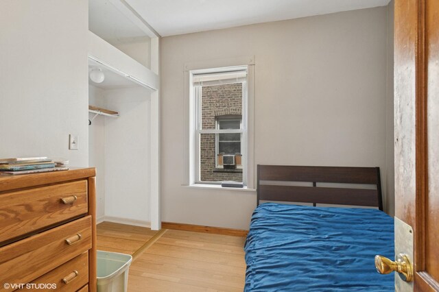 2416 N Avers Ave, Chicago, IL 60647 - bedroom with light wood-type flooring, baseboards, and a closet