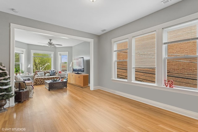 2416 N Avers Ave, Chicago, IL 60647 - living room with baseboards, light wood-type flooring, and a ceiling fan