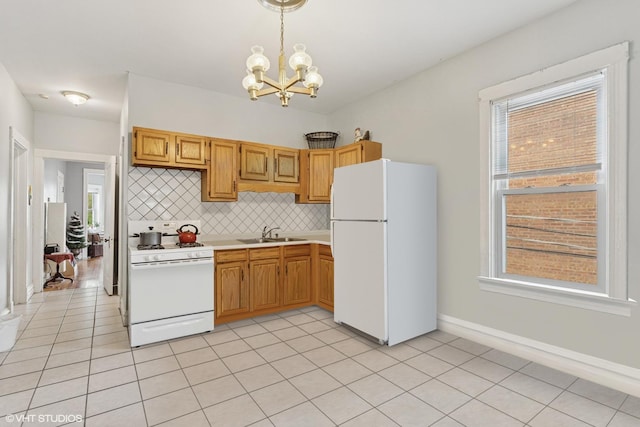 2416 N Avers Ave, Chicago, IL 60647 - kitchen featuring white appliances, a sink, a chandelier, light countertops, and tasteful backsplash