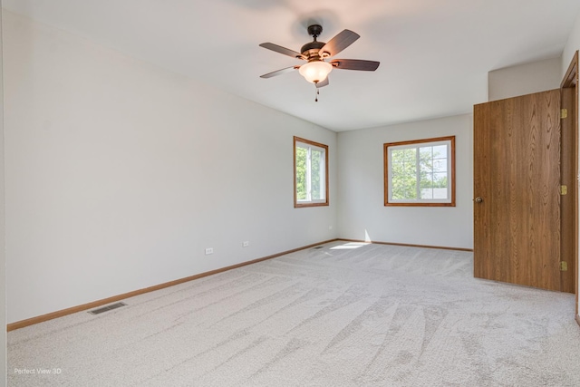2675 Dorothy Dr, Aurora, IL 60504 - unfurnished bedroom featuring light carpet, baseboards, and ceiling fan