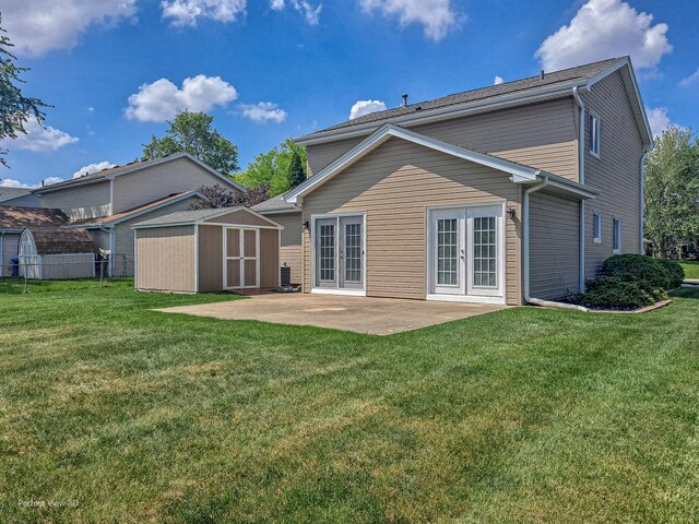2675 Dorothy Dr, Aurora, IL 60504 - rear view of house with french doors, a storage shed, a patio, and an outbuilding