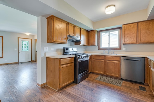 2675 Dorothy Dr, Aurora, IL 60504 - kitchen with stainless steel appliances, a sink, under cabinet range hood, and dark wood-style floors