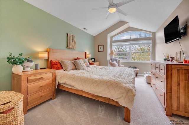 bedroom featuring vaulted ceiling, light colored carpet, and ceiling fan