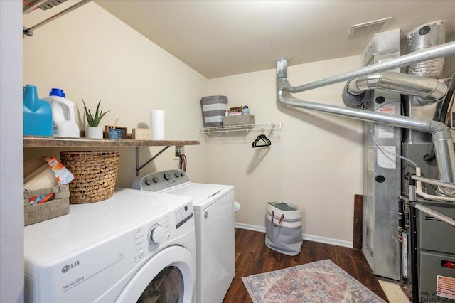 laundry room with washer and clothes dryer, wood finished floors, and baseboards