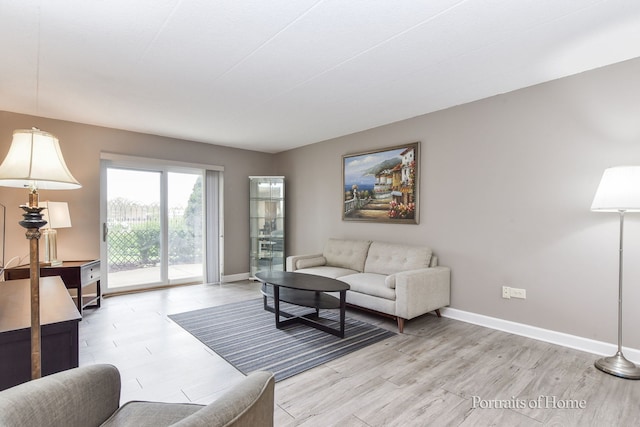 living area with light wood finished floors and baseboards