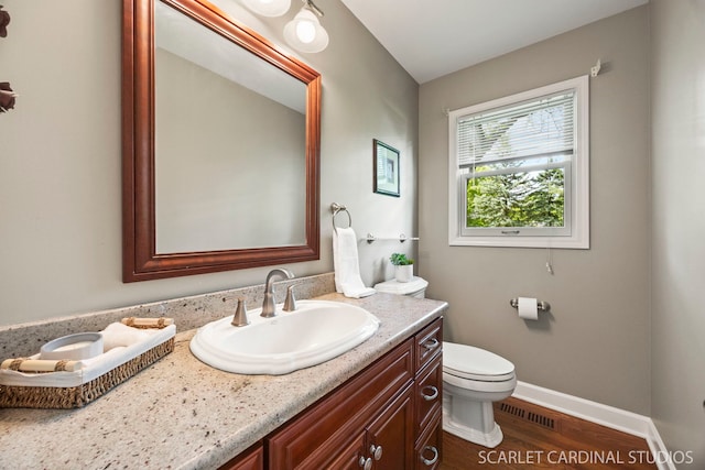 833 Shiloh Cir, Naperville, IL 60540 - bathroom with toilet, wood finished floors, vanity, and baseboards