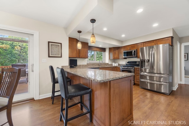 833 Shiloh Cir, Naperville, IL 60540 - kitchen featuring stainless steel appliances, a peninsula, brown cabinets, wood finished floors, and recessed lighting