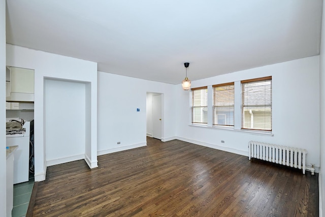 5060 N Claremont Ave Unit 2W, Chicago, IL 60625 - unfurnished living room featuring radiator heating unit, dark wood-style flooring, and baseboards