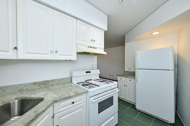 5060 N Claremont Ave Unit 2W, Chicago, IL 60625 - kitchen featuring white appliances, under cabinet range hood, white cabinets, dark tile patterned floors, and recessed lighting