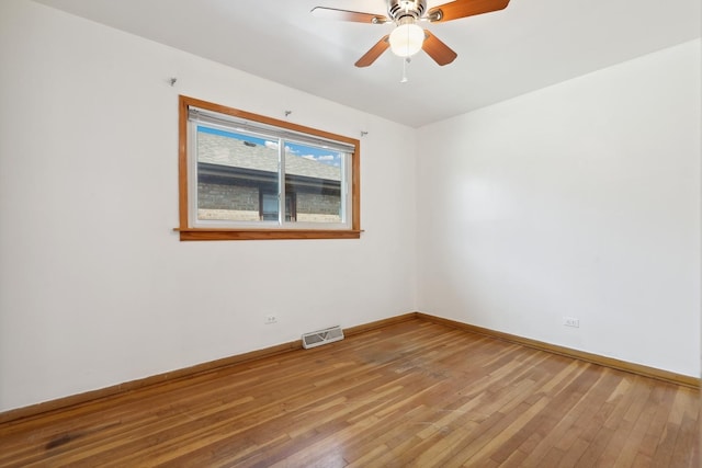 unfurnished room featuring wood-type flooring, baseboards, and a ceiling fan