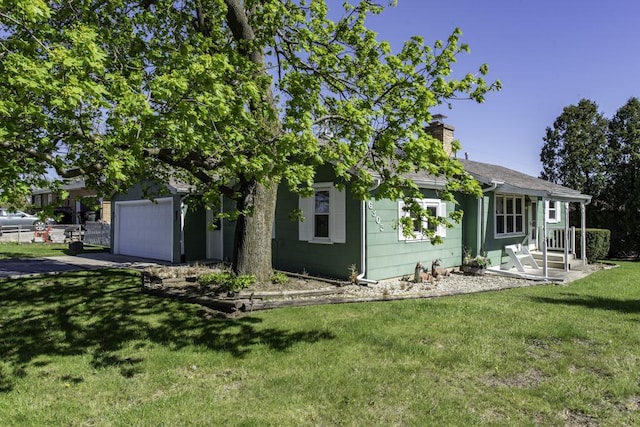 6305 247th Ave, Paddock Lake, WI 53168 - rear view of property with a lawn, a chimney, asphalt driveway, and a garage