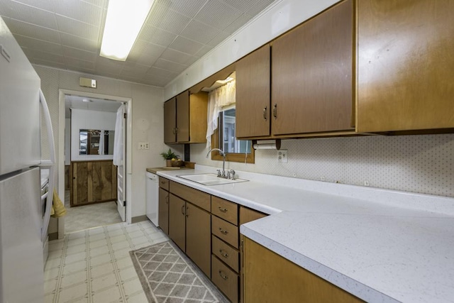 6305 247th Ave, Paddock Lake, WI 53168 - kitchen with a sink, white appliances, light floors, light countertops, and brown cabinetry