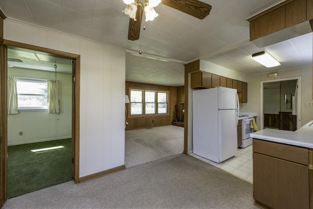 6305 247th Ave, Paddock Lake, WI 53168 - kitchen with white appliances, light countertops, ceiling fan, open floor plan, and light carpet