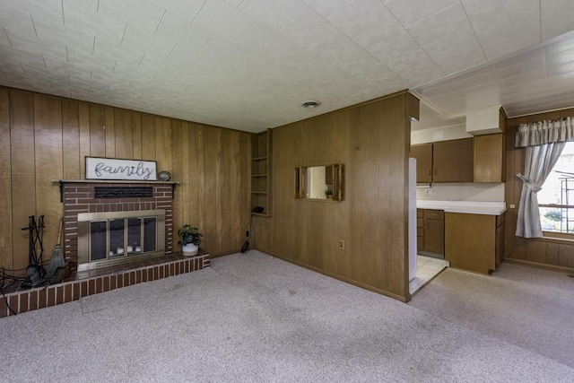 6305 247th Ave, Paddock Lake, WI 53168 - unfurnished living room featuring wooden walls, carpet floors, a fireplace, and baseboards