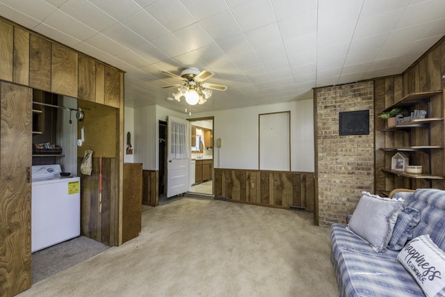 6305 247th Ave, Paddock Lake, WI 53168 - living area featuring washer / clothes dryer, light carpet, wooden walls, a wainscoted wall, and ceiling fan
