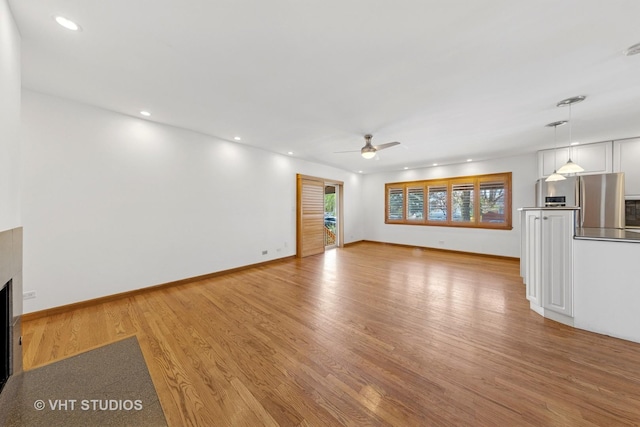 3913 N Kedvale Ave Unit A, Chicago, IL 60641 - unfurnished living room with ceiling fan, light wood-style floors, recessed lighting, baseboards, and a fireplace