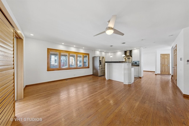 3913 N Kedvale Ave Unit A, Chicago, IL 60641 - unfurnished living room with light wood-style floors, a ceiling fan, recessed lighting, and baseboards