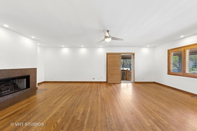 3913 N Kedvale Ave Unit A, Chicago, IL 60641 - unfurnished living room with a fireplace, light wood-type flooring, baseboards, ceiling fan, and recessed lighting