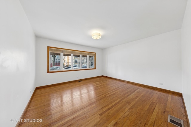 3913 N Kedvale Ave Unit A, Chicago, IL 60641 - unfurnished room featuring wood finished floors and baseboards