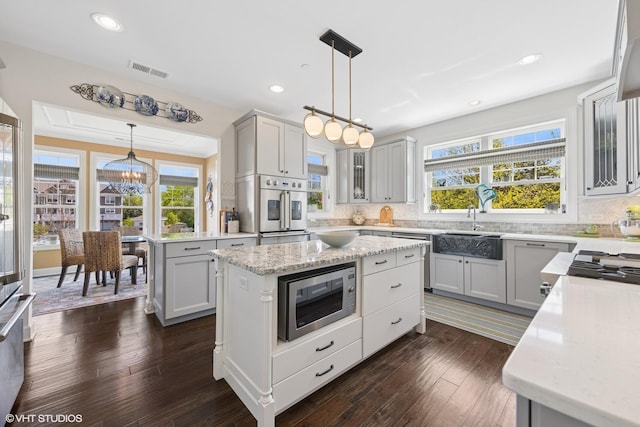 149 W Kennedy Ln Unit 208, Hinsdale, IL 60521 - kitchen featuring stainless steel appliances, a center island, decorative backsplash, glass insert cabinets, and recessed lighting