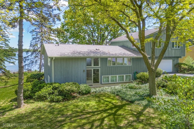 907 Division St, Barrington, IL 60010 - rear view of property featuring a garage, a shingled roof, and a yard