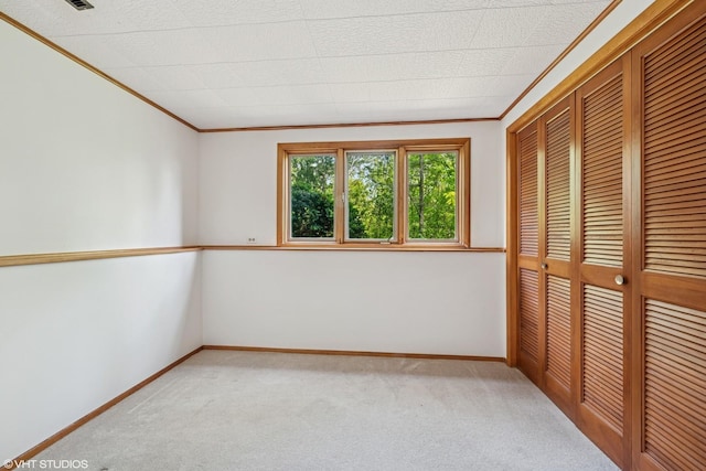 907 Division St, Barrington, IL 60010 - unfurnished bedroom with carpet flooring, crown molding, and a closet