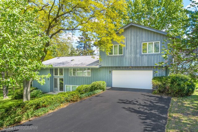 907 Division St, Barrington, IL 60010 - view of front of home featuring an attached garage and asphalt driveway