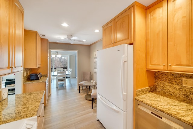 kitchen with freestanding refrigerator, dishwasher, decorative backsplash, a ceiling fan, and light stone counters