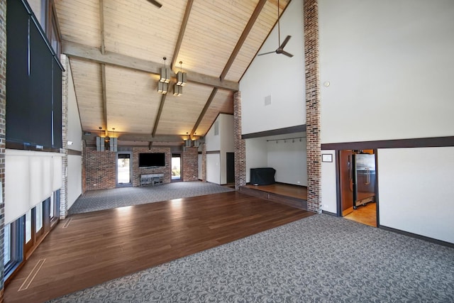 unfurnished living room with a fireplace, high vaulted ceiling, wooden ceiling, wood finished floors, and carpet floors