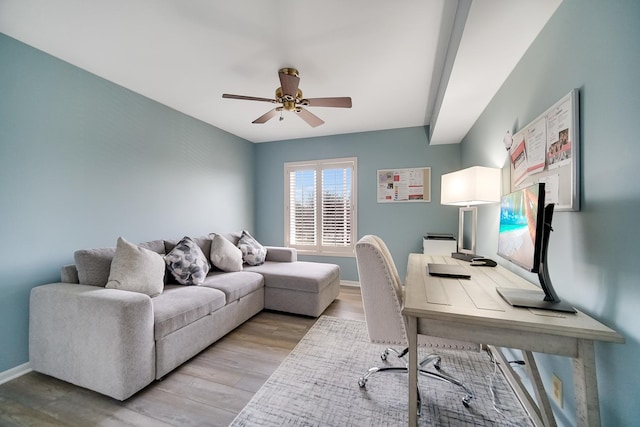 home office featuring ceiling fan, light wood-type flooring, and baseboards