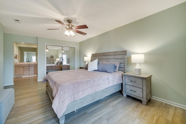 bedroom with light wood-style floors, a closet, baseboards, and ceiling fan