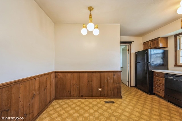 830 Silver Rock Ln, Buffalo Grove, IL 60089 - kitchen with black appliances, light flooring, a wainscoted wall, light countertops, and wooden walls
