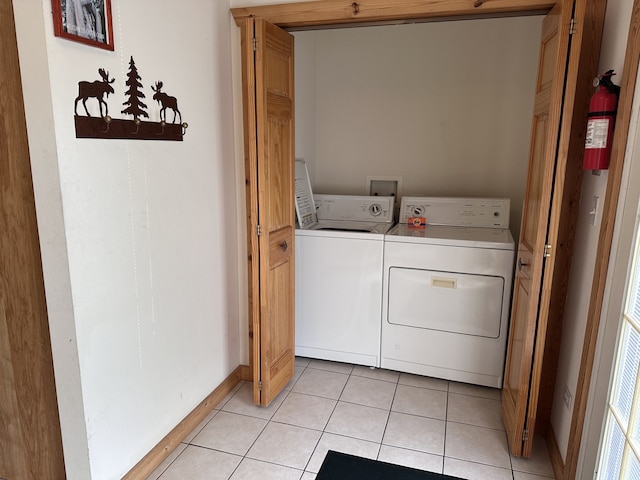 2643 N Il Route 178th Hwy Unit J-4, Utica, IL 61373 - washroom with separate washer and dryer, light tile patterned floors, and baseboards