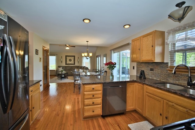 1729 Hidden Oaks Ct, Plainfield, IL 60586 - kitchen featuring freestanding refrigerator, dishwasher, a sink, open floor plan, and a peninsula