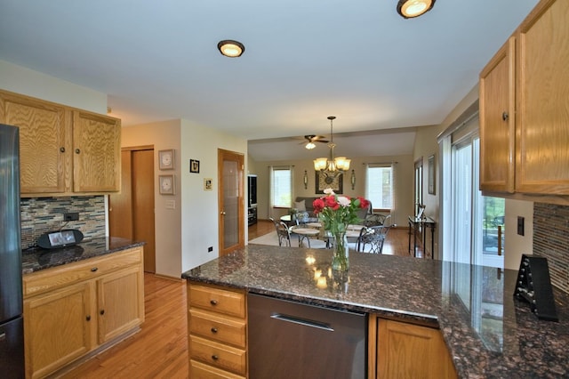 1729 Hidden Oaks Ct, Plainfield, IL 60586 - kitchen featuring light wood-type flooring, backsplash, dark stone countertops, and a peninsula