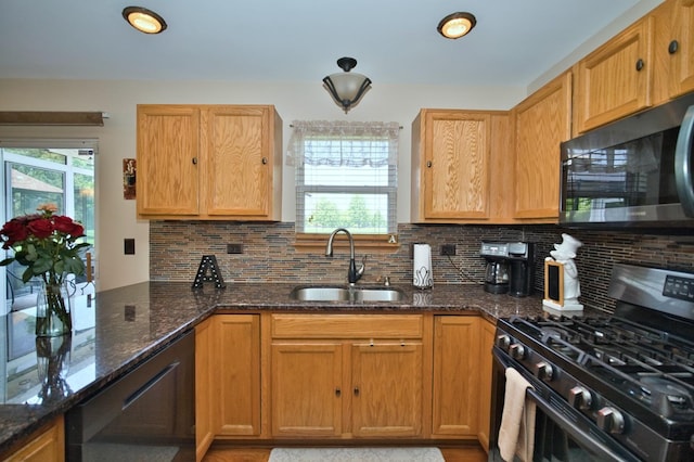 1729 Hidden Oaks Ct, Plainfield, IL 60586 - kitchen featuring stainless steel range with gas cooktop, a sink, black dishwasher, tasteful backsplash, and dark stone counters