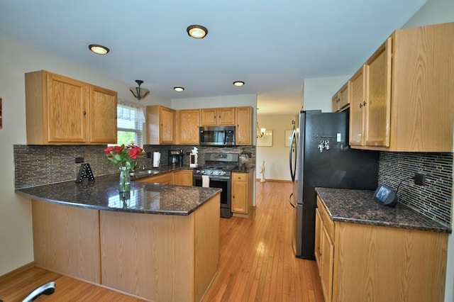 1729 Hidden Oaks Ct, Plainfield, IL 60586 - kitchen with appliances with stainless steel finishes, a peninsula, dark stone counters, backsplash, and recessed lighting