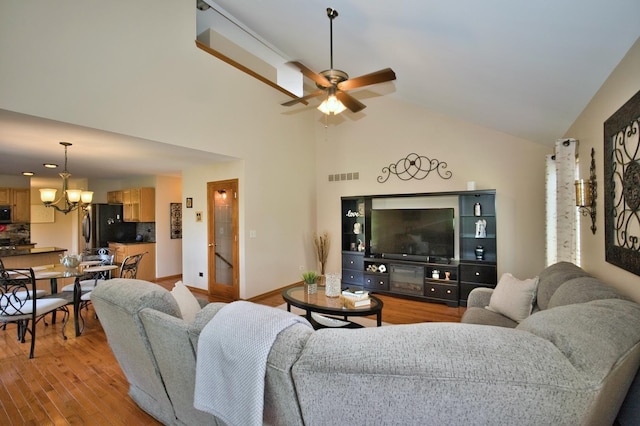 1729 Hidden Oaks Ct, Plainfield, IL 60586 - living room featuring a chandelier, light wood-style flooring, ceiling fan, and high vaulted ceiling