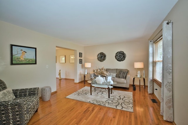 1729 Hidden Oaks Ct, Plainfield, IL 60586 - living room with hardwood / wood-style flooring and baseboards