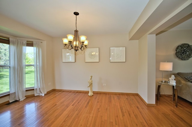 1729 Hidden Oaks Ct, Plainfield, IL 60586 - unfurnished dining area with a chandelier, light wood-style floors, and baseboards