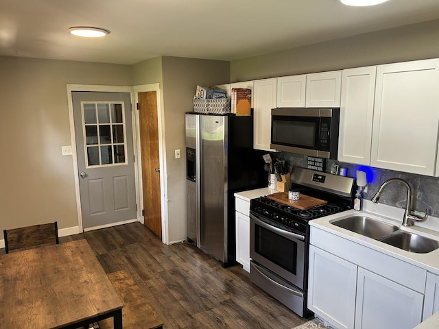 210 E Edgelawn Dr, Plano, IL 60545 - kitchen with stainless steel appliances, a sink, dark wood-type flooring, and white cabinetry