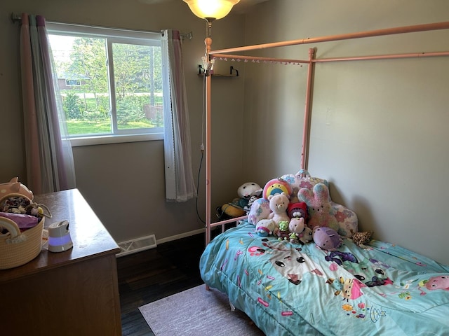 210 E Edgelawn Dr, Plano, IL 60545 - bedroom featuring dark wood-style flooring and baseboards