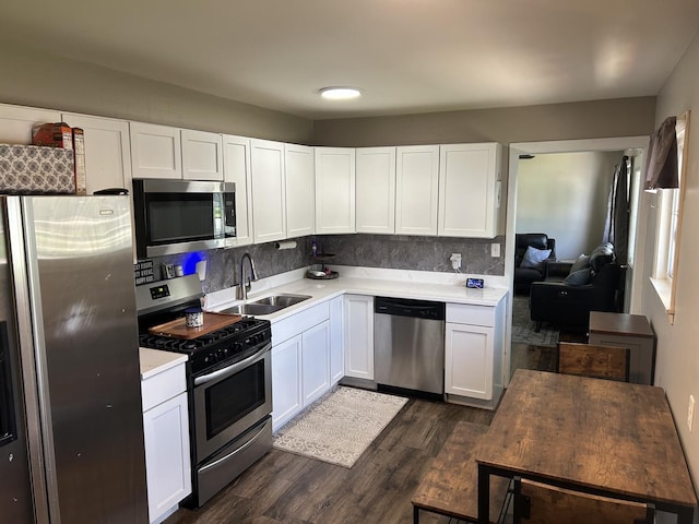 210 E Edgelawn Dr, Plano, IL 60545 - kitchen with appliances with stainless steel finishes, a sink, dark wood finished floors, and white cabinets