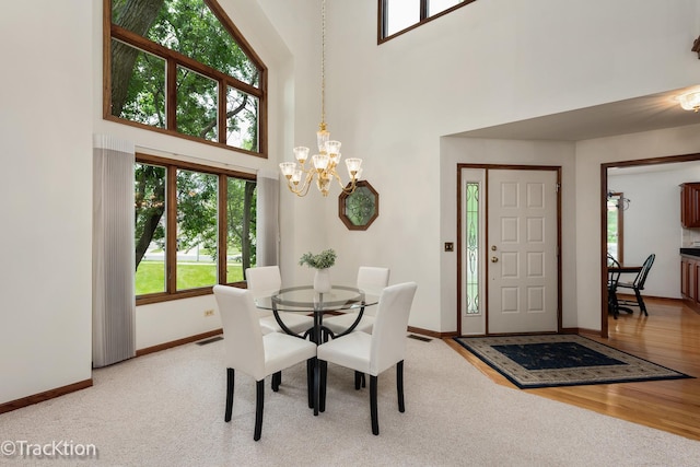 2325 Durand Dr, Downers Grove, IL 60515 - dining space with a towering ceiling, a chandelier, and wood finished floors