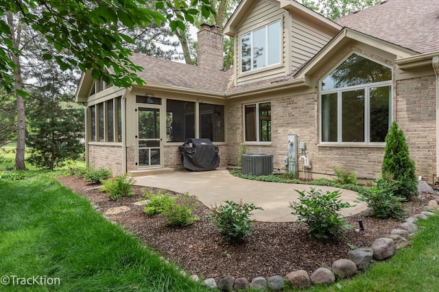 2325 Durand Dr, Downers Grove, IL 60515 - rear view of property featuring a sunroom, a patio area, a chimney, and brick siding