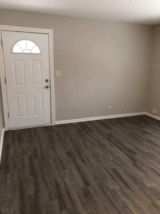 entryway featuring baseboards and dark wood-type flooring