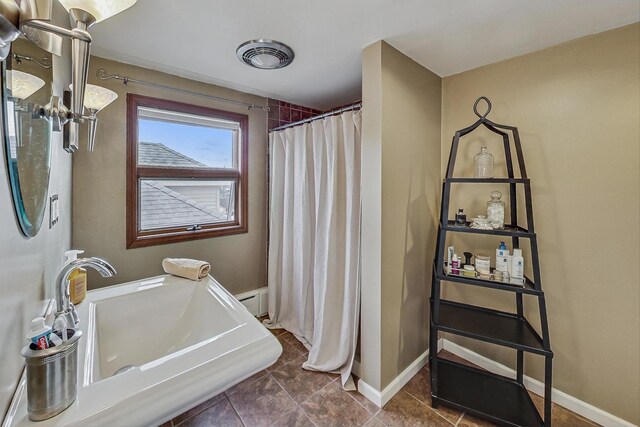 2742 N 76th Ct, Elmwood Park, IL 60707 - full bath with curtained shower, baseboards, and a sink