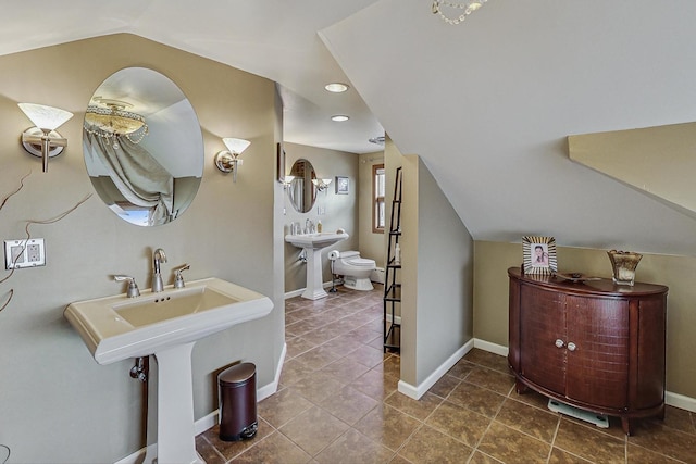 2742 N 76th Ct, Elmwood Park, IL 60707 - bathroom featuring tile patterned floors, lofted ceiling, a sink, baseboards, and recessed lighting