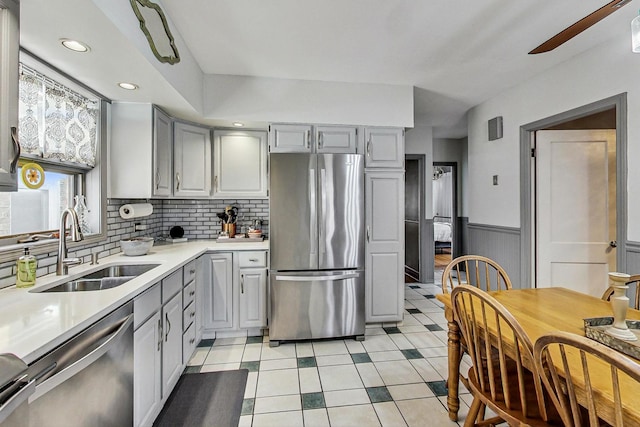 2742 N 76th Ct, Elmwood Park, IL 60707 - kitchen with appliances with stainless steel finishes, a sink, gray cabinets, a ceiling fan, and light countertops