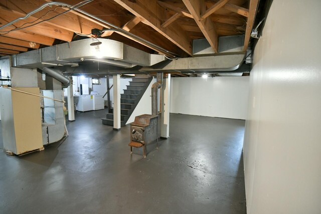 313 N Jackson St, Waukegan, IL 60085 - basement featuring stairway, washer and dryer, and heating unit